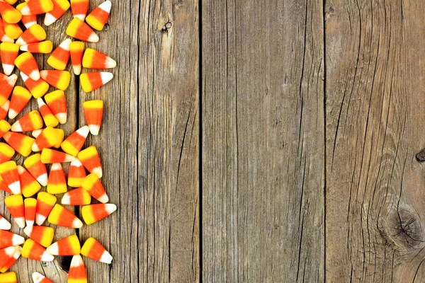 Halloween candy corn side border against wood — Stock Photo, Image