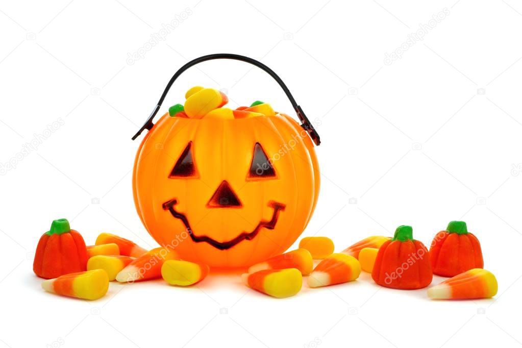 Halloween Jack o Lantern candy collector with scattered candy over white