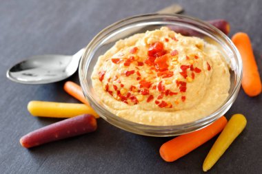 Humus ve bebek gökkuşağı havuç kayrak üzerinde kapat