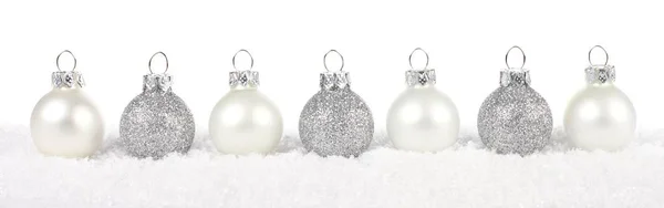 Silver and white Christmas bauble border in snow over white