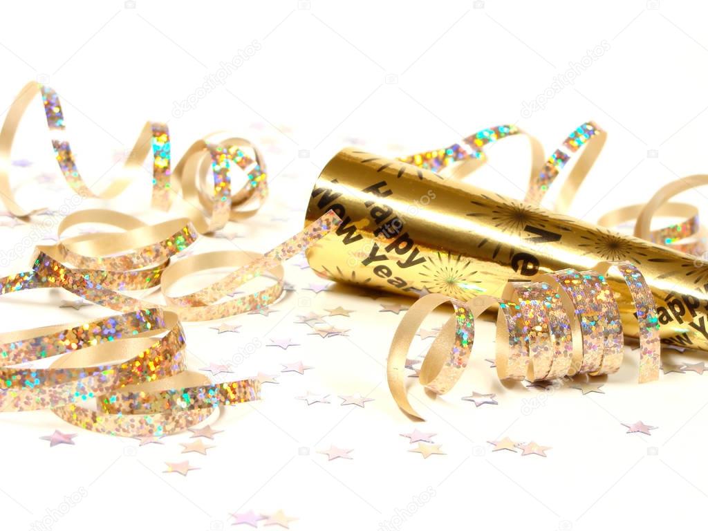 New Year's Eve noisemaker and party confetti, close up on a white background