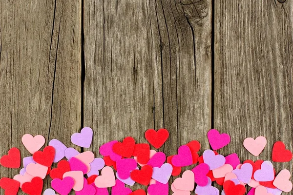 Colorful Paper Valentines Day Hearts Forming Bottom Border Rustic Wood — Stock Photo, Image