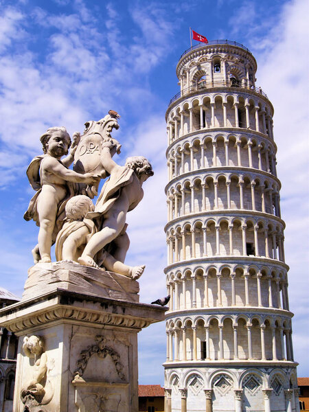 Famous Leaning Tower of Pisa and cherub statue under blue skies