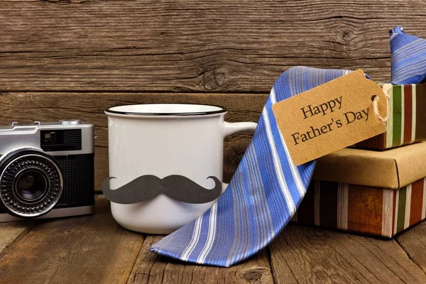Group of Fathers Day gifts with greeting card. Side view on a rustic wood background.