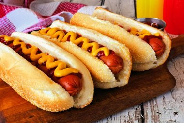 Ketçap ve hardal ile geleneksel sosisli sandviç. Sahne tahta arka plan ile kapatmak.