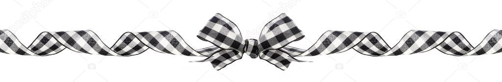Long Christmas border of black and white buffalo plaid bow and ribbon isolated on a white background