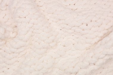 Samimi, kalın yün battaniye. Dalgalı doku arka planı. Krem rengi.