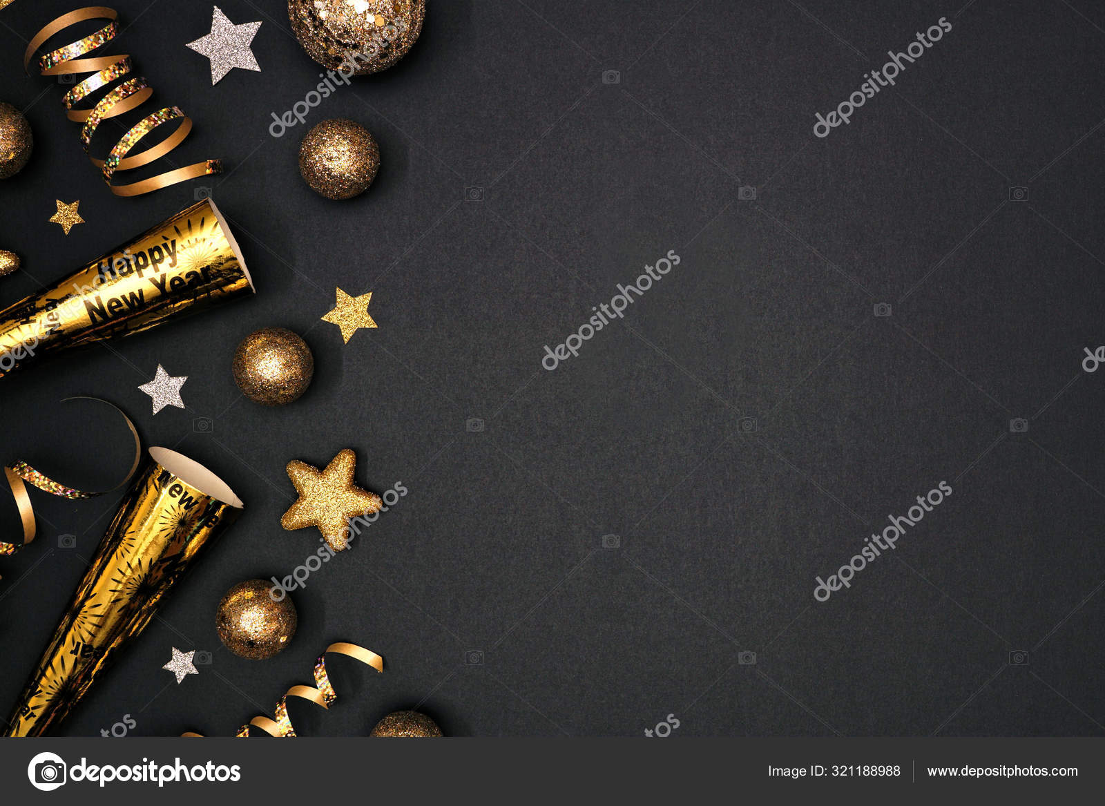 New Years party frame of shiny black and gold black and gold streamers and  confetti. Top down view on a black background. Stock Photo