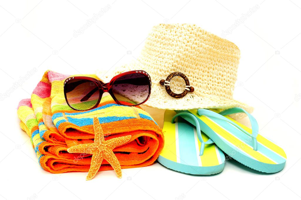 Collection of beach accessories, towel, sunglasses, hat, sandals, isolated on white