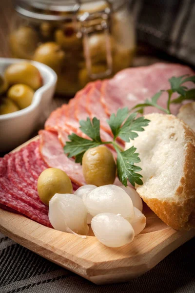 Tapas with sliced sausage, salami, olives, marinated onions, cuc — Stock Photo, Image