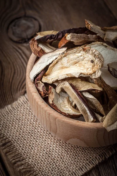 Dried mushrooms in wooden bowl. — Stock Photo, Image