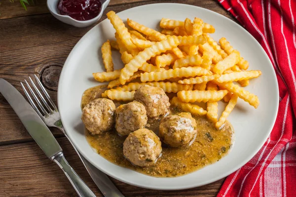 Meatballs with french fries in dill sauce. — Stock Photo, Image