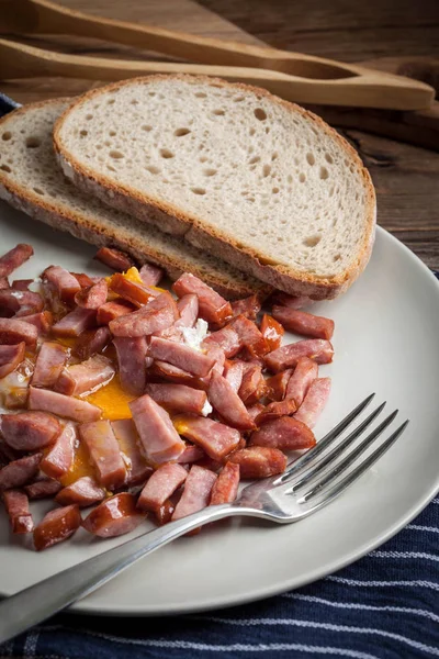 Pieces of sausage fried with egg. — Stock Photo, Image