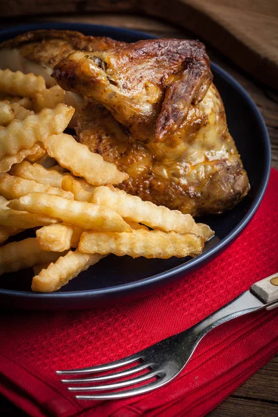 Roasted chicken with french fries on a plate. — Stock Photo, Image