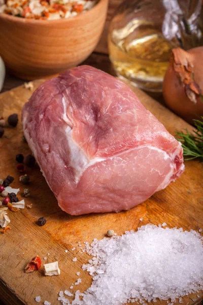 Piece of pork on a wooden board. — Stock Photo, Image