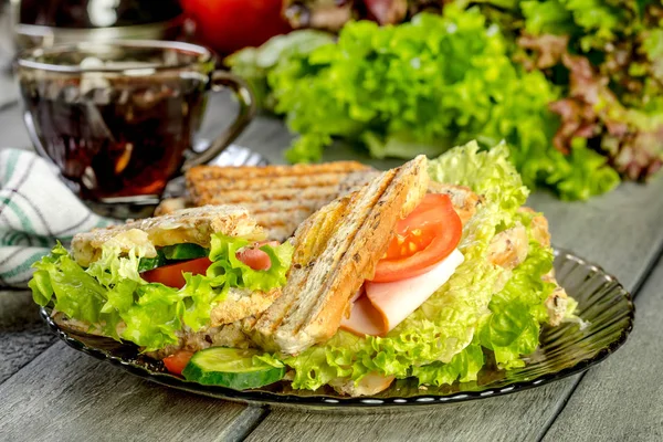 Panini sandwich with ham, tomato and lettuce. — Stock Photo, Image