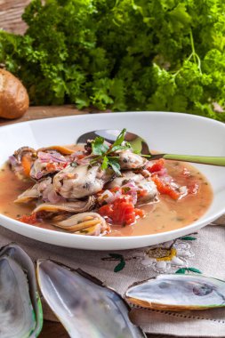 Pişmiş domates soslu midye.