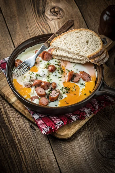 Tasty cooked egg with chopped sausages. — Stock Photo, Image