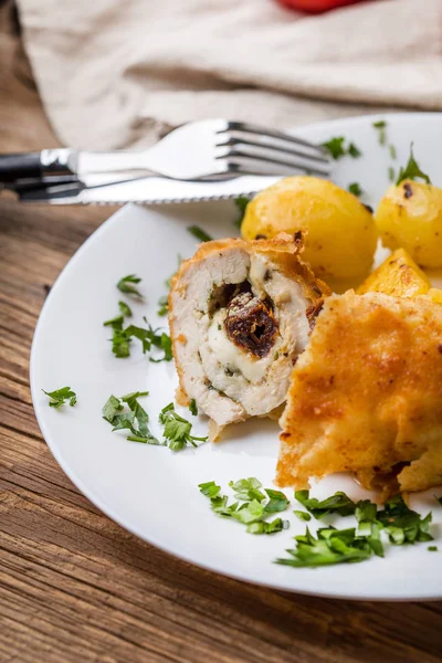 Chicken breast stuffed with cheese and dried tomatoes. — Stock Photo, Image