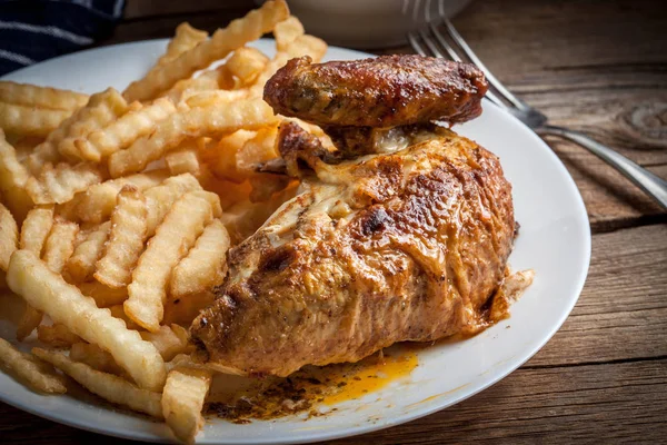 Roasted chicken with french fries on a plate. — Stock Photo, Image