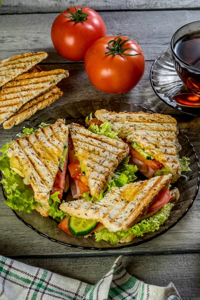 Panini sandwich with ham, tomato and lettuce. — Stock Photo, Image