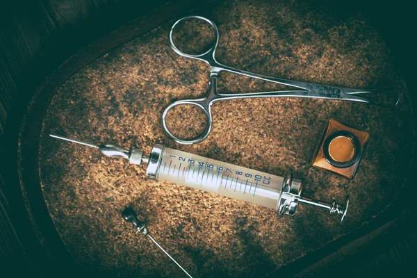 Old medicine equipment on wooden background.