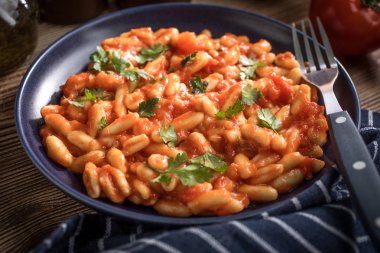 Cavatelli pasta with fresh tomato sauce. clipart