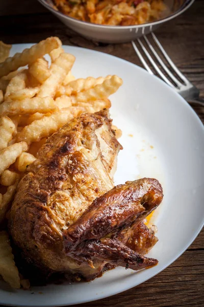 Roasted chicken with french fries on a plate. — Stock Photo, Image