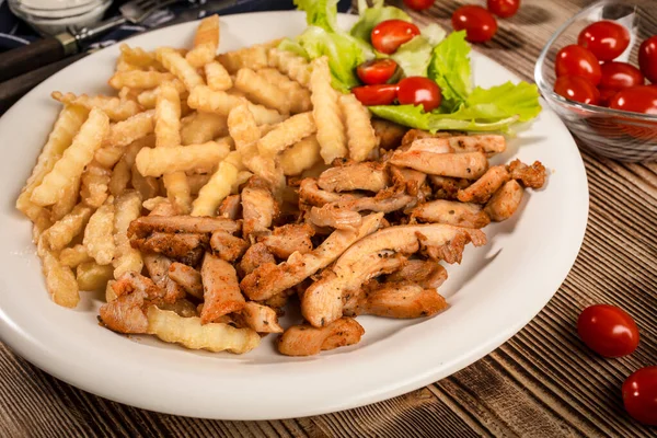 Greek gyros dis with fries and salad — Stock Photo, Image