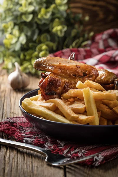 Baked chicken wings with french fries. — Stock Photo, Image