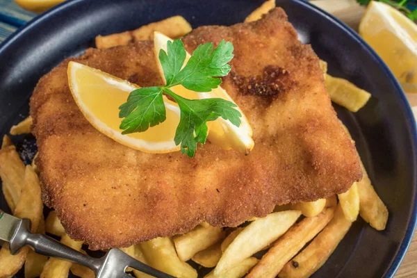 A piece of fried cod with fries on a plate. — Stock Photo, Image