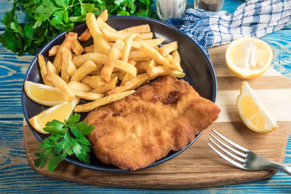 A piece of fried cod with fries on a plate. — Stock Photo, Image