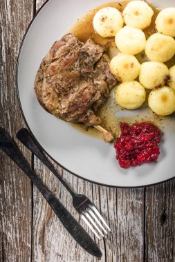 Kızarmış ördek bacağı, patates köftesi ve kızılcık..