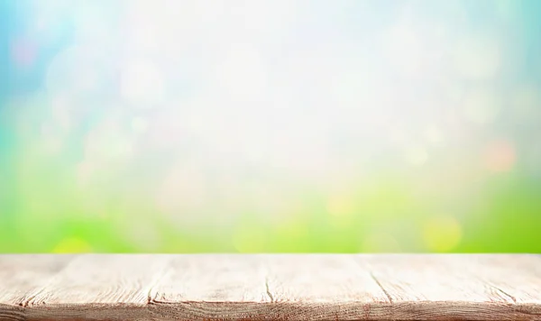 Wooden table and blurred green spring or summer background. East — ストック写真