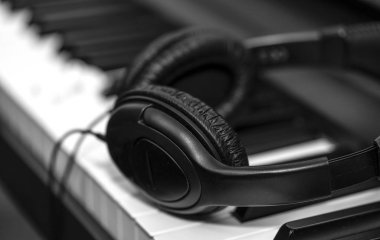 Müzik sentezleyici klavyesinde kulaklık. Kulaklıklar elektronik piyanoda. Müzik arkaplanı