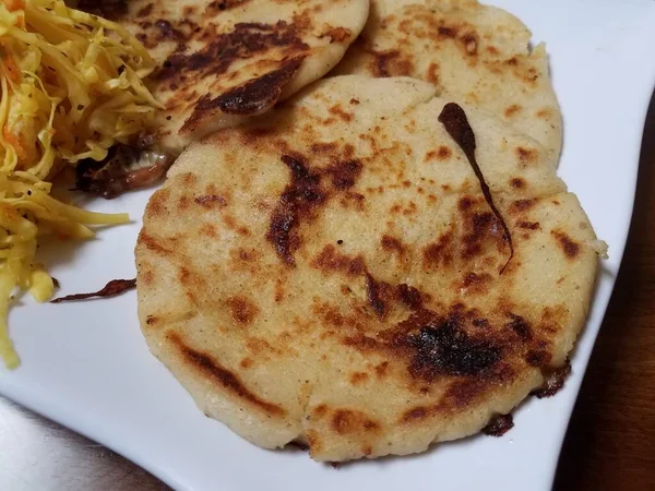 Pupusa or tortilla stuffed with cheese on plate with cabbage — Stock Photo, Image