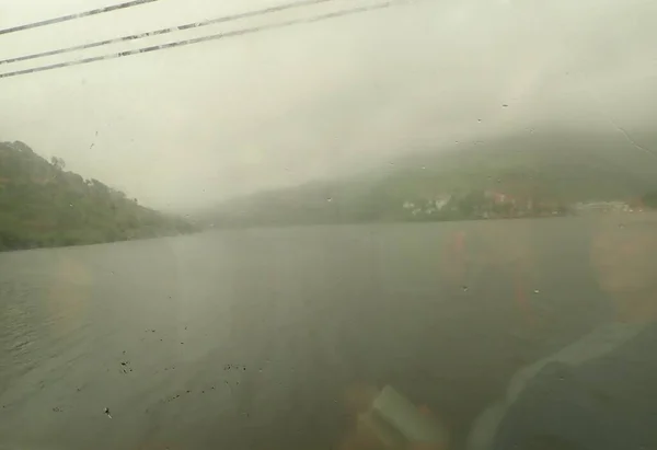 river water from train window on rainy day