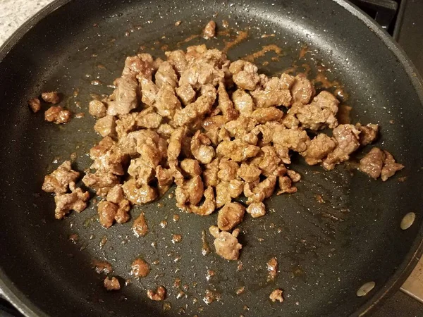 Steak meat cooking in frying pan or skillet — Stock Photo, Image