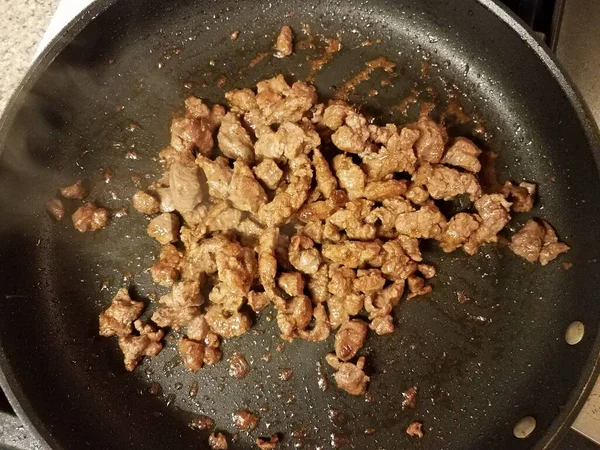 Ground steak cooking in hot frying pan — Stok fotoğraf