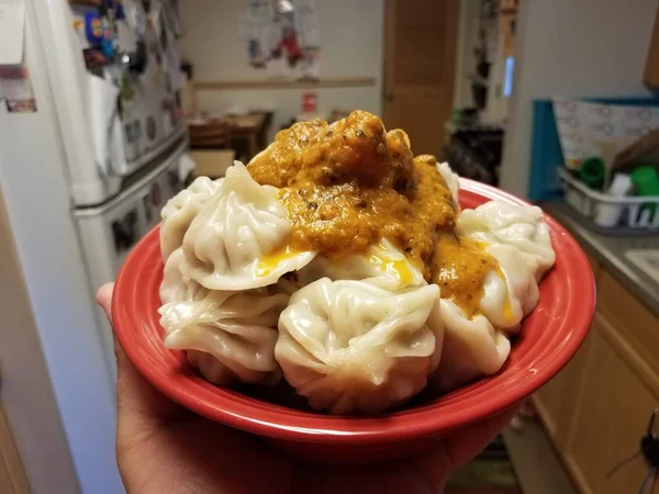 Albóndigas y salsa picante en tazón rojo en la cocina — Foto de Stock