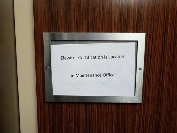 Paper elevator certification is located in maintenance office sign — Stock Photo, Image