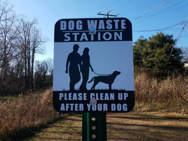 Dog waste station sign please clean up after your dog — Stock Photo, Image