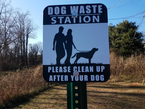 Dog waste station sign please clean up after your dog — Stock Photo, Image