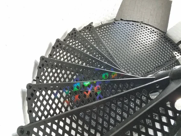 Rainbow colors on black metal steps or stairs in lighthouse — Stock Photo, Image