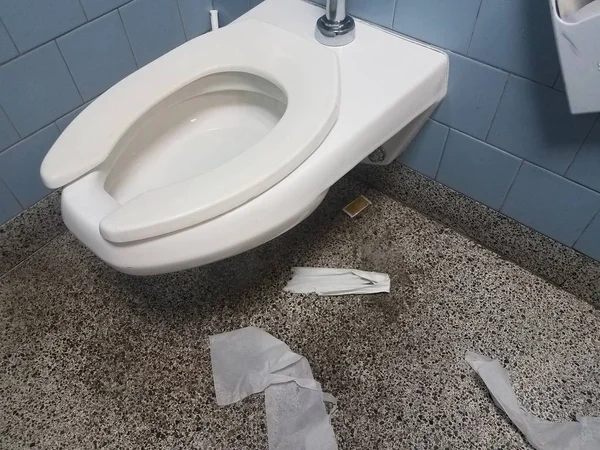 Toilet and dirty bathroom floor with toilet paper — 스톡 사진