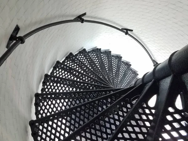 Black iron metal spiral staircase and white wall in lighthouse — Stock Fotó