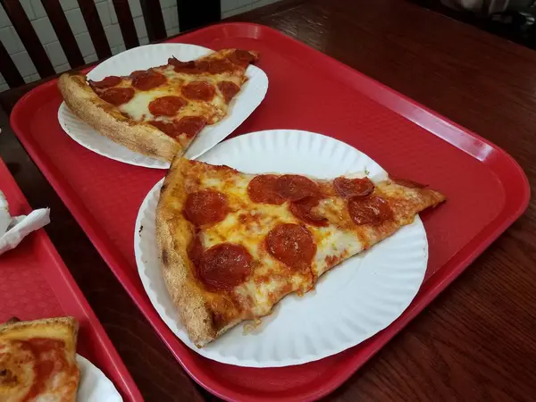 Large pepperoni and cheese slices of pizza on red tray — Stok fotoğraf