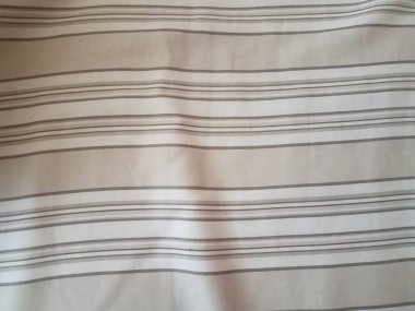 brown and white sheets with parallel lines
