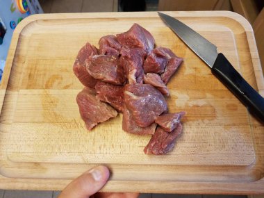 raw beef meat on wood cutting board with knife
