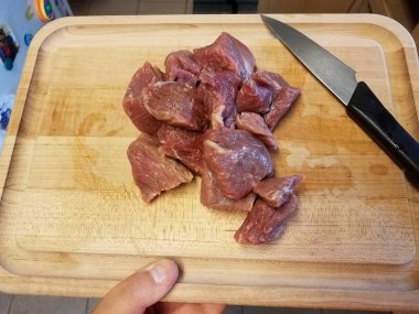 raw beef meat on wood cutting board with knife
